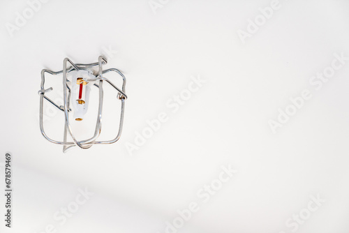 Smoke detectors on the ceiling of a house or public space. 