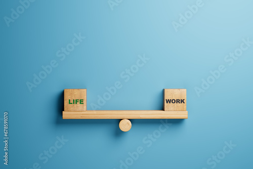 balance between life and work concept. life and work words balancing on wooden seesaw photo