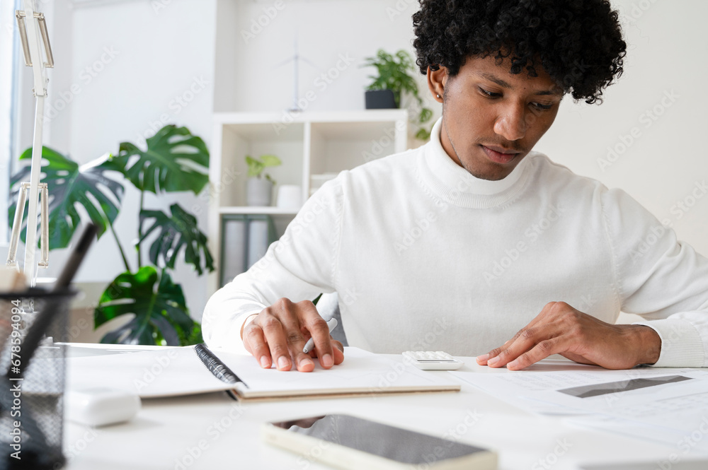 Focused businessman working at desk with documents in home office Focused businessman working at desk with documents in home office