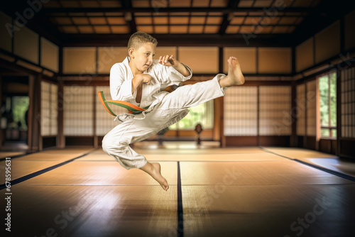 Photos boy practising martial arts in a traditional dojo