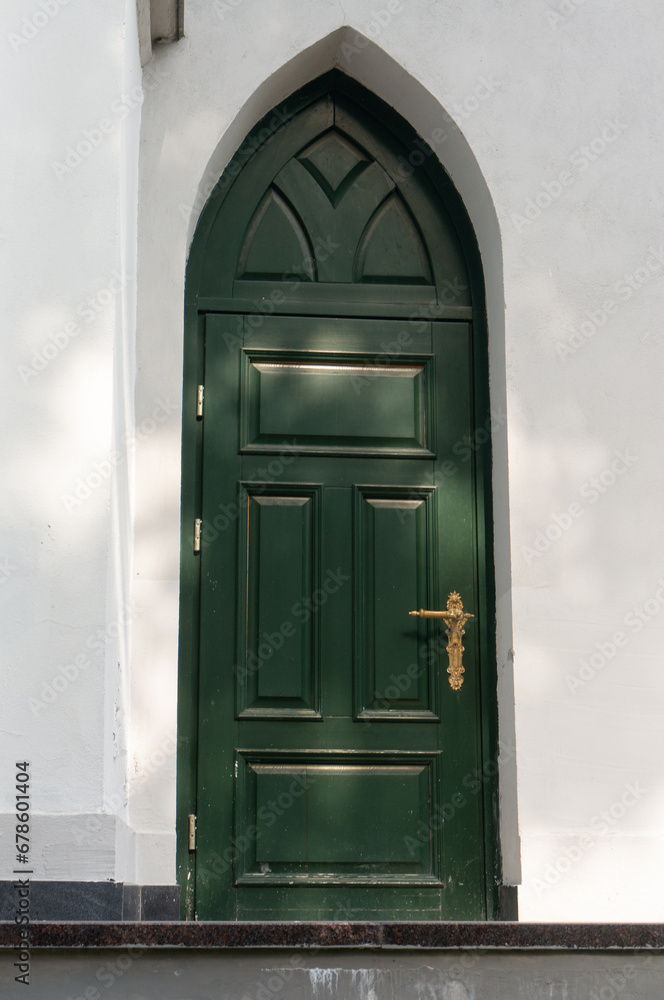 Green door with a golden handle of St. John's Lutheran Church in Grodno. Green door with a golden handle of St. John's Lutheran Church in Grodno.