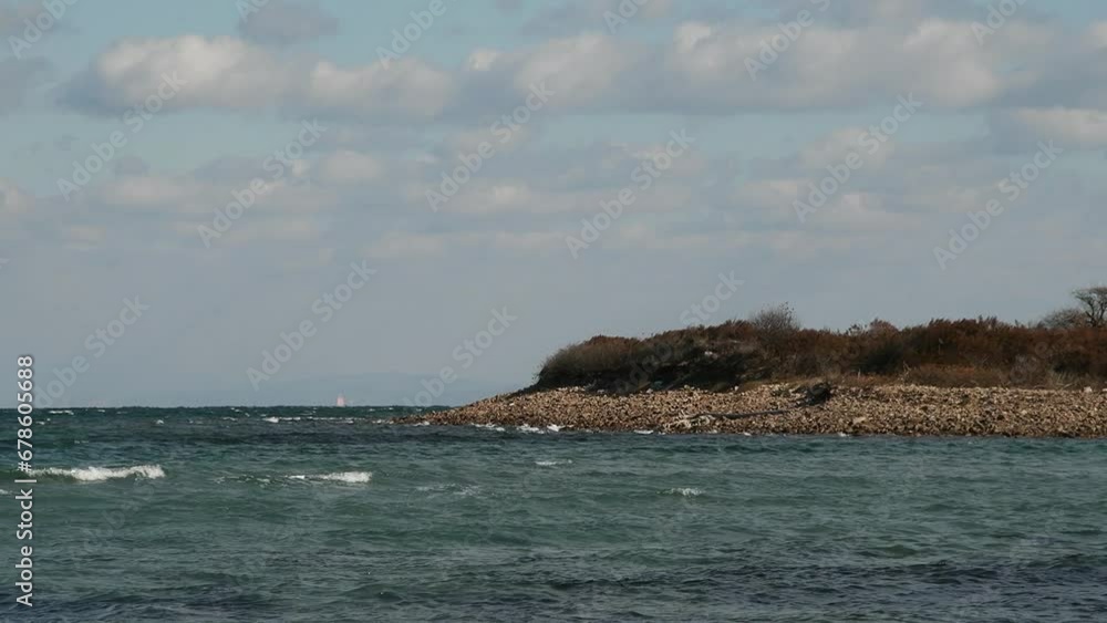 Northern Cold Sea at the mountain shore. Wild ocean with rocky coast. Northern Cold Sea at the mountain shore. Wild ocean with rocky coast.