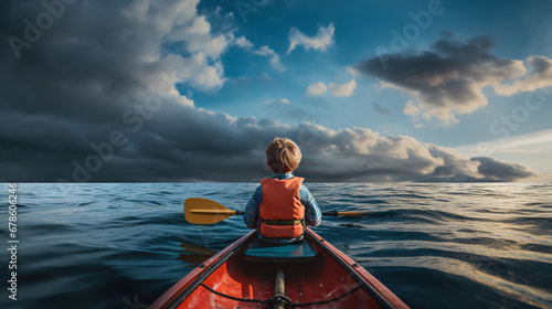 Child in a kayak at sea © Hassan