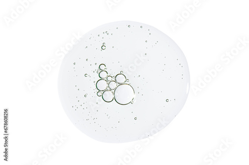 A drop of body serum or cosmetic oil with bubbles. Liquid skin care product. Isolated on a white background.