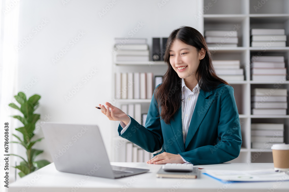 Asian business woman is online meeting using laptop the computer in the office. Asian business woman is online meeting using laptop the computer in the office.