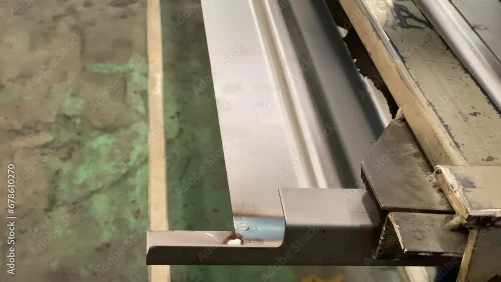Hands using a grinding machine to grind iron. The rotating grinding blade emits sparks. Industrial concept - Manufacturing process Hands using a grinding machine to grind iron. The rotating grinding blade emits sparks. Industrial concept - Manufacturing process