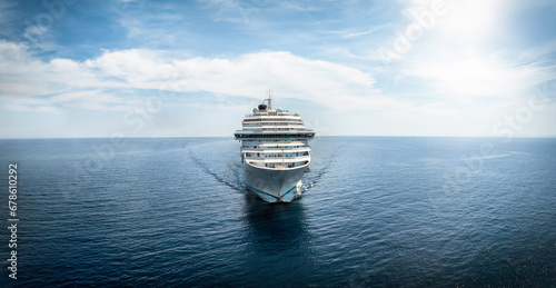 Fototapeta Naklejka Na Ścianę i Meble -  Front view of a generic cruise ship traveling with speed over calm ocean with copy space