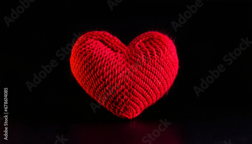 Red heart knitted on a black background