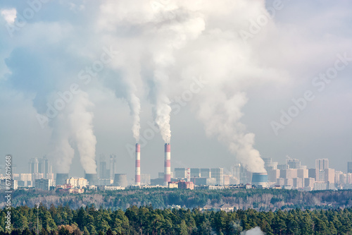 Steam from huge boilers rises into the city sky. Centralized city heating system. The steam flying out of the chimneys into the sky is epic.