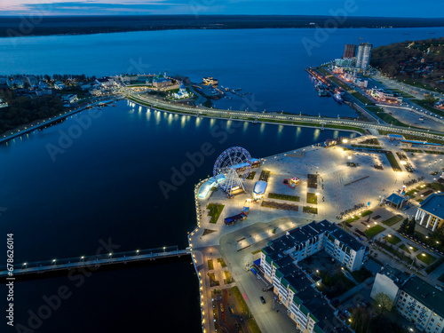 Fotografie Night aerial view of Cheboksary cityscape on banks of Volga River, Chuvashia, Ru