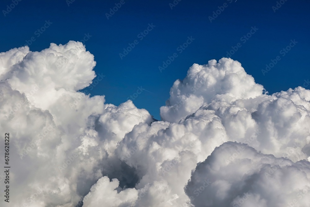 Bellegarde, France - September 6 2021: a field of clouds in the sky visible from a passing air plane Bellegarde, France - September 6 2021: a field of clouds in the sky visible from a passing air plane