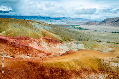 Martian landscapes in the Altai Mountains. Red colorful mountains in Altai, Siberia, Russia. Kyzyl-Chin valley, also called as Mars valley. Natural texture of sandstone.