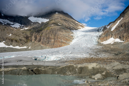Melting  Steindalsbreen Glacier and a proglacial lake in the Steindalen Valley.  Water is milky and colored because of the glacial flour.  Lyngen Alps, Northern Norway photo
