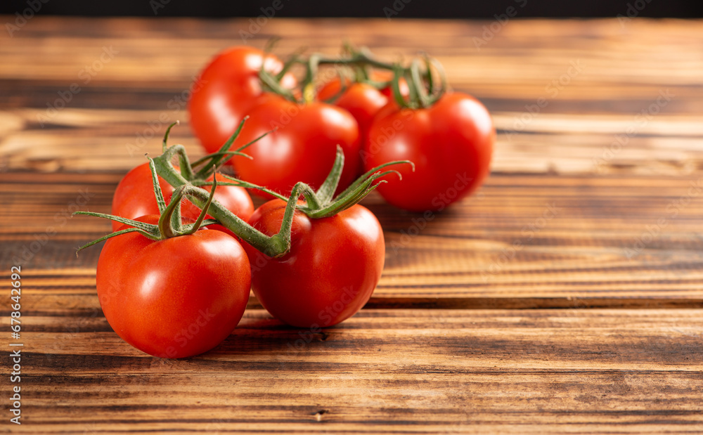 Tomatoes, beautiful bunch of tomatoes in detail on rustic wood, selective focus. Tomatoes, beautiful bunch of tomatoes in detail on rustic wood, selective focus.