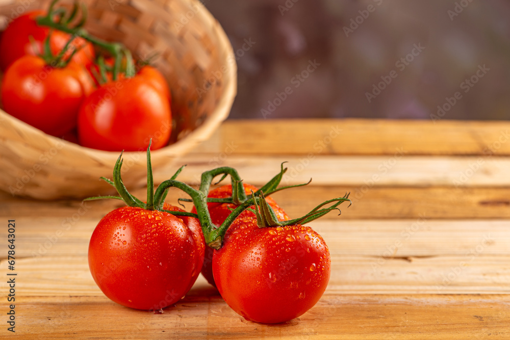 Tomatoes, beautiful arrangement with tomatoes in a basket on rustic wood, selective focus. Tomatoes, beautiful arrangement with tomatoes in a basket on rustic wood, selective focus.
