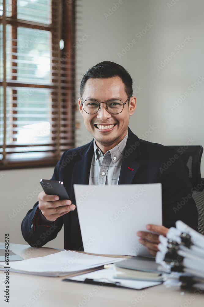 Businessman is sitting and working in the office, Employee is looking for information on laptop, An entrepreneur is talking on the phone with a company customer, startup. Businessman is sitting and working in the office, Employee is looking for information on laptop, An entrepreneur is talking on the phone with a company customer, startup.
