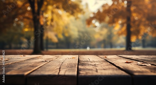 Golden Autumn Morning Light Bathing a Wooden Table with Scattered Fall Leaves photo