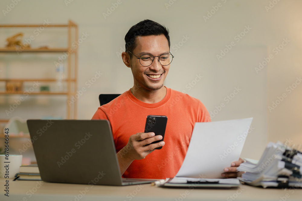 Businessman is working in the office and talking on the phone with a partner, Entrepreneurs use smartphones to find information in order to present it, Working in a private office at a company. Businessman is working in the office and talking on the phone with a partner, Entrepreneurs use smartphones to find information in order to present it, Working in a private office at a company.