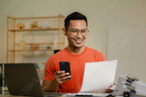 Businessman is working in the office and talking on the phone with a partner, Entrepreneurs use smartphones to find information in order to present it, Working in a private office at a company.