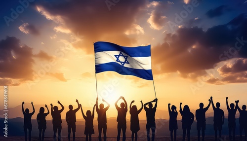 Group of people with israeli flag on sunset background photo