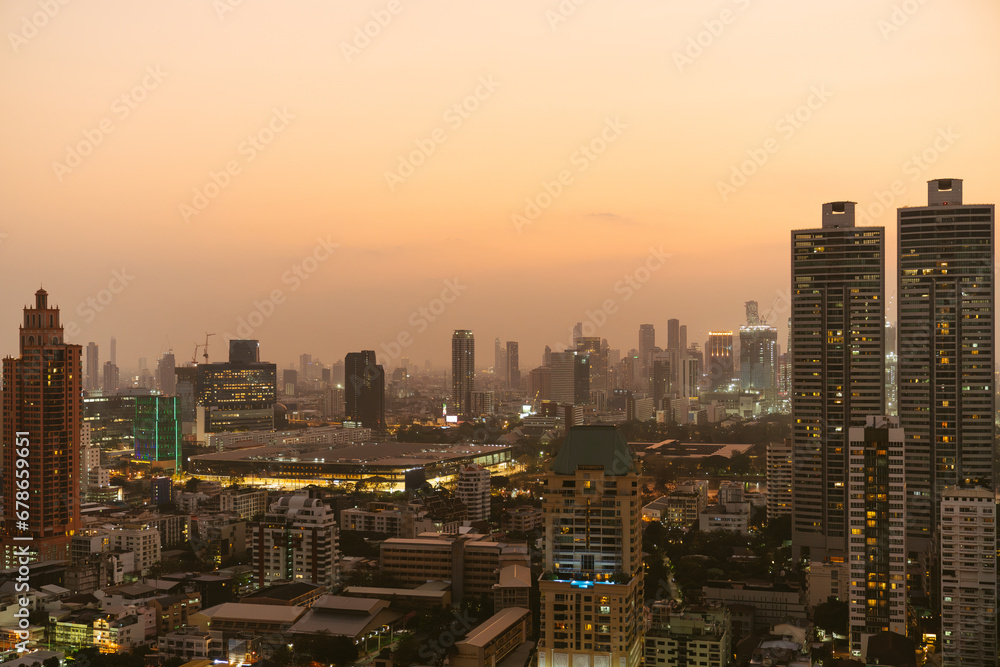 custom made wallpaper toronto digitalA modern city skyline captured at sunset, with high-rise buildings illuminated by the golden glow of evening light.