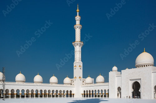 Tall minaret tower of the Sheikh Zayed Grand Mosque built with white marble stone. Abu Dhabi, UAE - 8 February, 2020 photo
