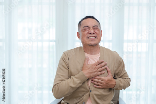 Middle age male touching at chest have pain cause of heart disease. health and people concept. Elderly man heart ache. treatment painful breathing.