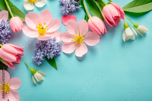 Spring flowers on blue background. Flat lay, top view, copy space.IA generativa