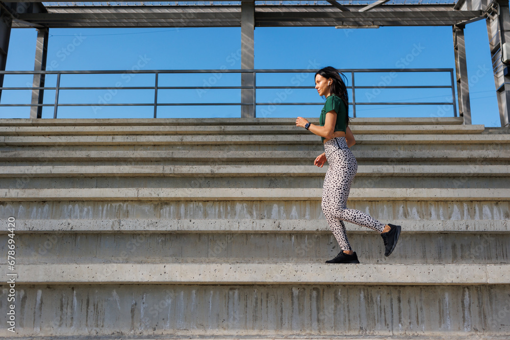 Young Female Runner Exercising in Athletic Stadium