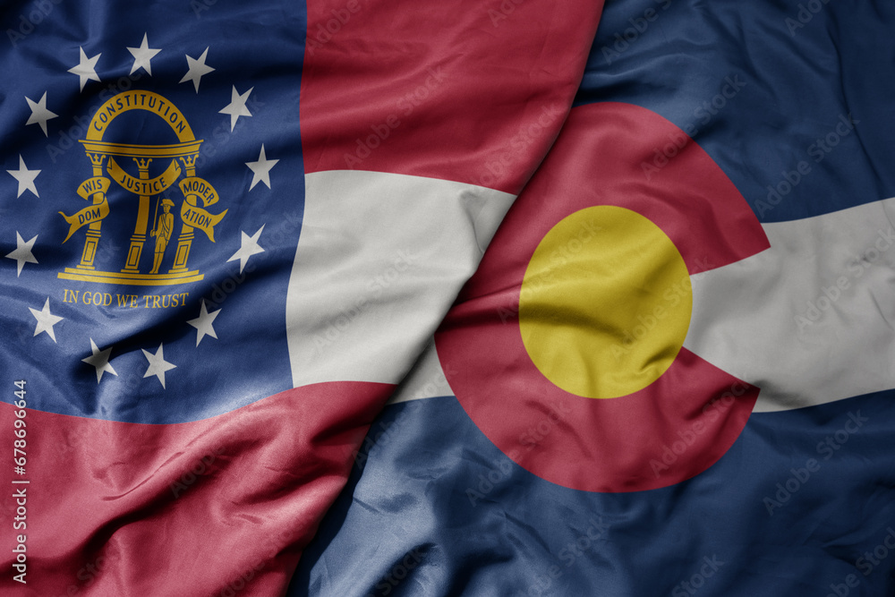 Fototapeta premium big waving colorful national flag of colorado state and flag of georgia state .