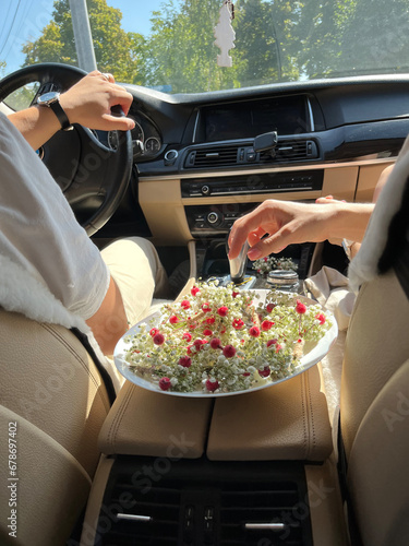 Boutonnieres on a white plate in the bride's car photo