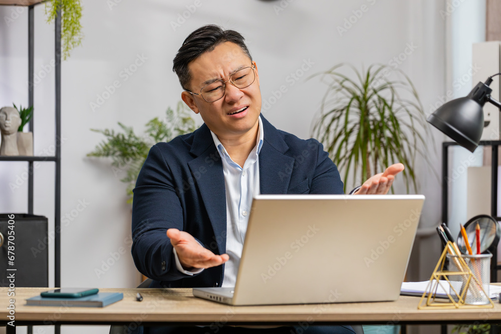 Asian middle-aged businessman programmer software developer working on laptop loses becoming surprised by bad news results, fortune loss fail at home office. Deadline, bankruptcy. Freelancer man Asian middle-aged businessman programmer software developer working on laptop loses becoming surprised by bad news results, fortune loss fail at home office. Deadline, bankruptcy. Freelancer man
