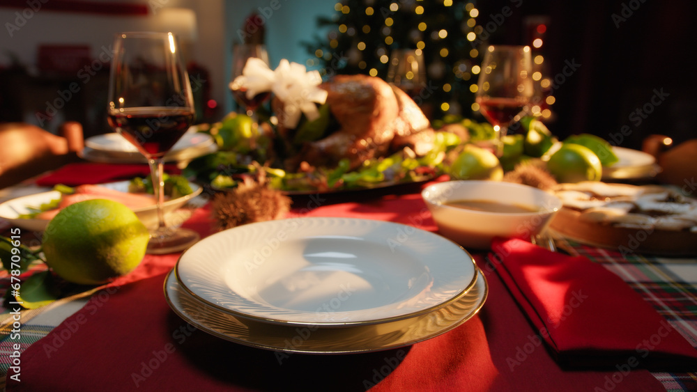 Fototapeta premium Christmas dinner table with food set for