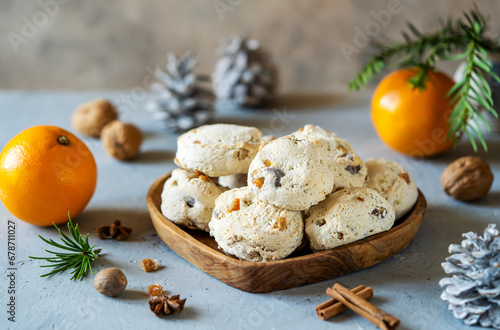 Italian traditional Christmas sweets Cavallucci over grey background with xmas or winter decoration, oranges and spices