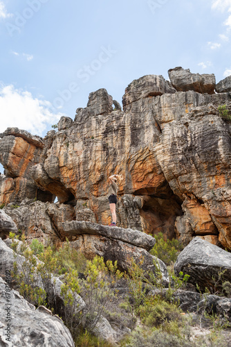 Woman looking at a rock formation in the mountains