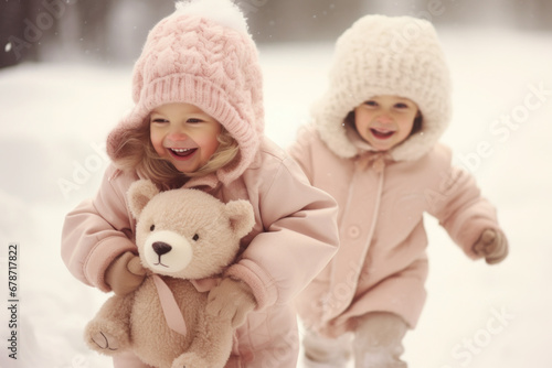 Little kids play happily and smilingly in the snow. Concept of winter holidays, Xmas and New Year, happy childhood, magical holiday atmosphere and snowfall. © lagano