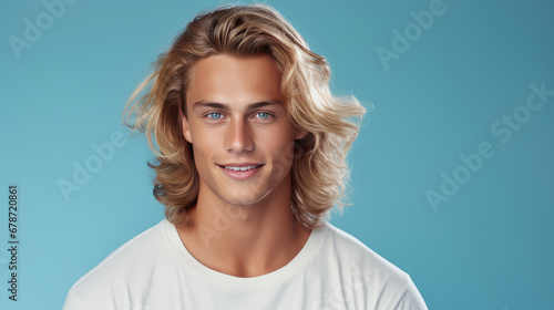 Obraz na plátně Elegant sexy smiling Caucasian blond man with blond and long hair with perfect skin, on a light blue background, banner