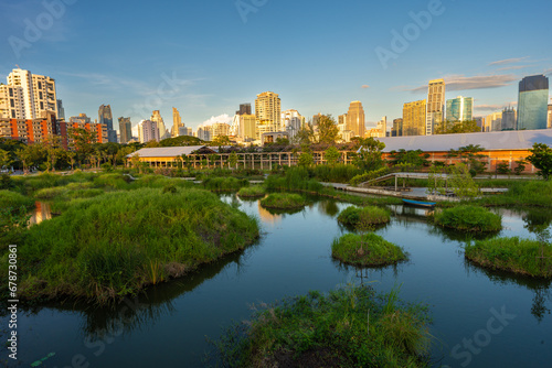 Benchakitti swamp river tropical forest park with modern office building photo