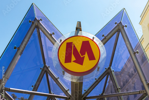 Entrance to underground in Warsaw, capital of Poland. Yellow round sing with red M letter and arrow