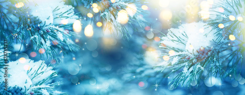  Christmas Tree. Christmas New Year Winter blurred background. Magic winter snow landscape. Christmas greeting card. Christmas lights. Space for text. Banner. © Irene