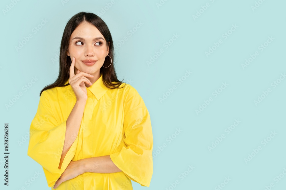 Curious young brunette woman looking at copy space Curious young brunette woman looking at copy space