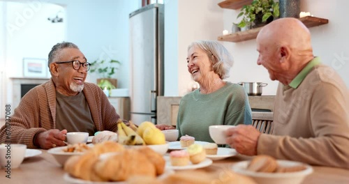 Breakfast, tea party and food with senior friends laughing in a retirement home together for bonding in the morning. Smile, drink and a group of funny old people chatting in an apartment kitchen