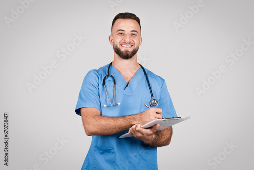 Fényképezés Happy male nurse with clipboard and stethoscope