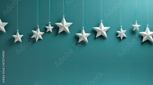  a group of white stars hanging from strings on a blue wall with a green wall behind them and a blue wall behind them with white stars hanging from the ceiling.