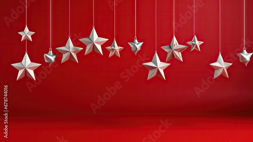  a group of white stars hanging from strings on a red background with a red wall in the background and a red wall in the foreground with a red wall.