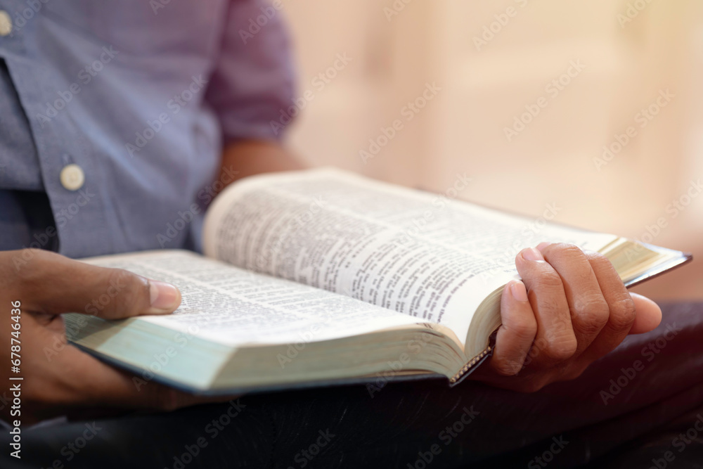 A close-up of a hand male opening and reading a book. A close-up of a hand male opening and reading a book.