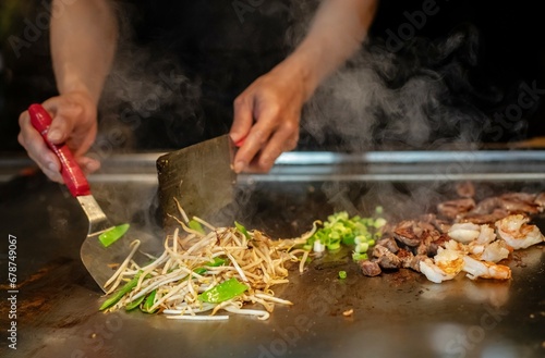 Chef cooking in Japanese teppanyaki restaurant