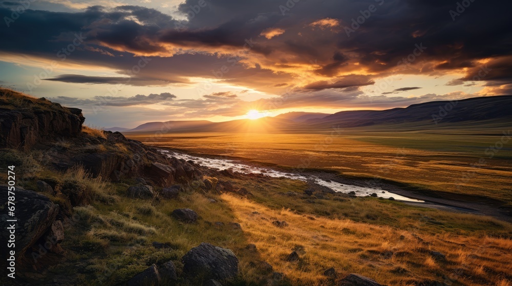  the sun is setting over a valley with a river in the foreground and mountains in the distance, with grass and rocks in the foreground, and a river in the foreground.