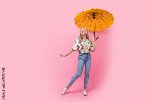 Full body photo of charming young woman wavy hair protection parasol look empty space new gucci boutique isolated on pink color background