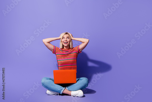 Full body photo of shocked girl junior game dev programmer hands head look up head with laptop features isolated on violet color background © deagreez